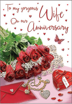 This anniversary card scene feels like a cherished love letter laid out on a table in a quiet Norbiton townhouse, the light falling in as softly as an early afternoon along Kingston Road. At the heart of the composition is a tight cluster of crimson red roses, their petals swirling in rich layers that look almost velvety under the glow. Fresh green leaves weave between the blooms, giving the arrangement a sense of life and movement, as if the bouquet has just been delivered and gently set down. To one side, a neatly addressed envelope rests half open, suggesting a handwritten message of devotion waiting to be read. A small piece of jewellery lies nearby, its polished surface reflecting glints of light, alongside a charming heart-shaped box that appears to hold tiny keepsakes collected over the years. Delicate heart-shaped confetti is scattered across the surface, leading the eye toward a beautifully scripted anniversary greeting on the card. A single butterfly motif adds a whimsical note, as though it has just fluttered into this quiet moment of celebration. The palette is dominated by passionate reds, warm ivory tones, and soft shadows, creating an intimate, romantic mood. Flowers Norbiton could have styled such a scene, with its blend of fragrant roses, sentimental touches, and understated elegance. The overall impression is one of deep, enduring love, quietly celebrated with flowers, gifts, and words that feel as personal and lasting as the partnership itself.